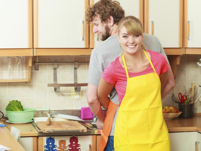 People, housework and housekeeping concept. Couple doing the washing up together in kitchen interior