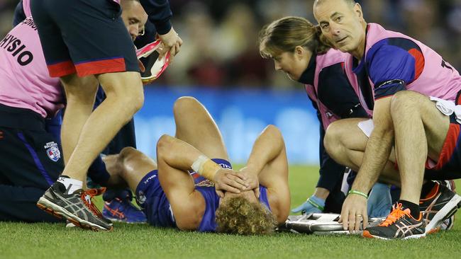 Mitch Wallis is helped by trainers after breaking both bones in his leg. Picture: Michael Klein