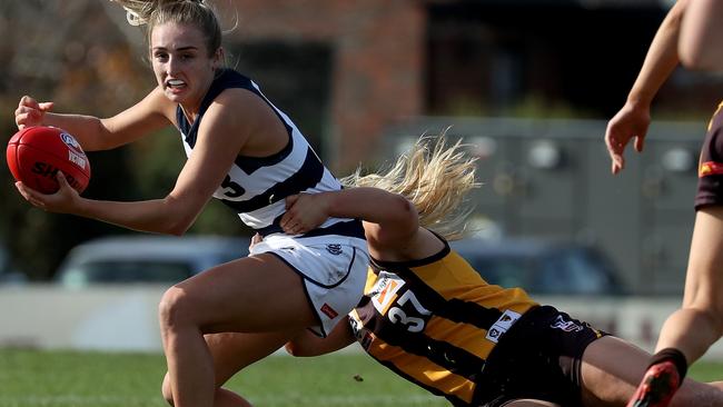 Hawthorn first-gamer Tayah Kelly lays a desperate tackle against Geelong’s Amy McDonald Picture: Mark Dadswell