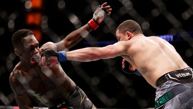 Robert Whittaker punches Israel Adesanya during UFC 271 in February. Carmen Mandato/Getty Images/AFP