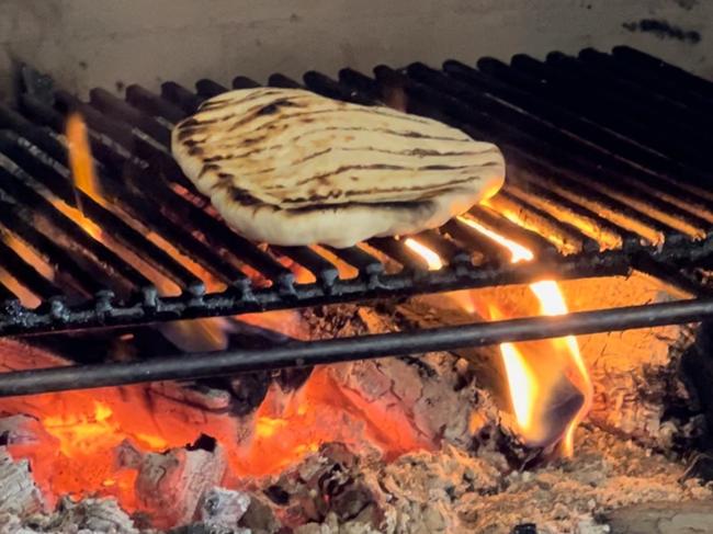 Agrarian Kitchen Experience. Cooking flatbread on the open oven. Picture: Philip Young