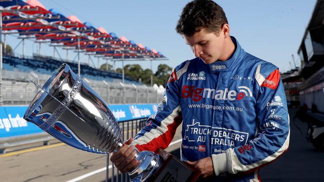 South Australian Supercars rookie Todd Hazelwood gets a close look at the new Adelaide 500 trophy in pit straight on Tuesday. Picture: CALUM ROBERTSON