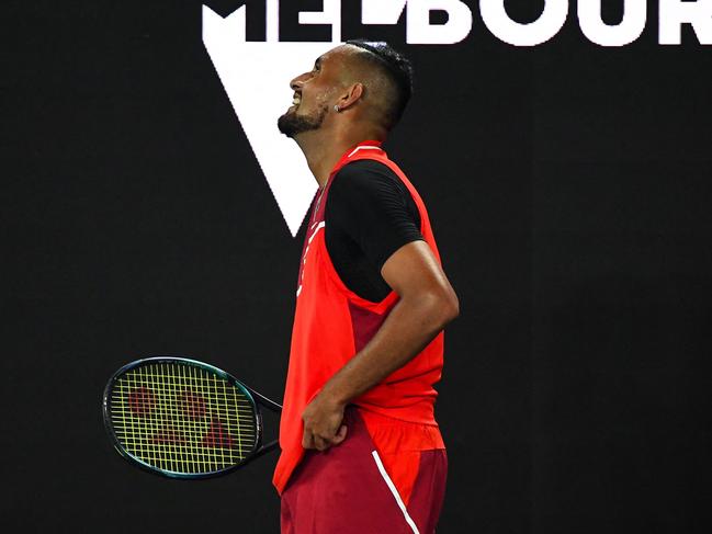 Australia's Nick Kyrgios reacts as he plays against Russia's Daniil Medvedev during their men's singles match on day four of the Australian Open tennis tournament in Melbourne on January 20, 2022. (Photo by William WEST / AFP) / -- IMAGE RESTRICTED TO EDITORIAL USE - STRICTLY NO COMMERCIAL USE --