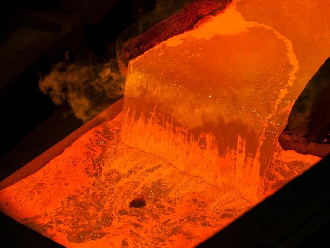 Molten copper is poured into a mold at the Aurubis AG metal refinery in Hamburg, Germany, on Wednesday, Dec. 4, 2013. The copper market's surplus next year may be smaller than currently forecast amid limited availability of the metal, according to Aurubis AG, the world's second-biggest producer. Photographer: Krisztian Bocsi/Bloomberg