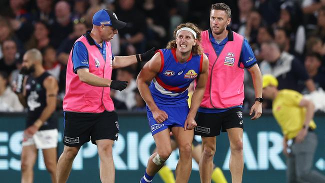 Bulldog Aaron Naughton heads to the bench in pain. Picture: Michael Klein