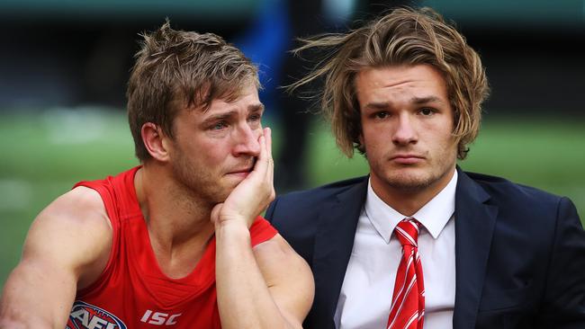 The pain of defeat for the Swans was obvious, as shown by Kieren Jack, seen here with brother Brandon. Picture. Phil Hillyard