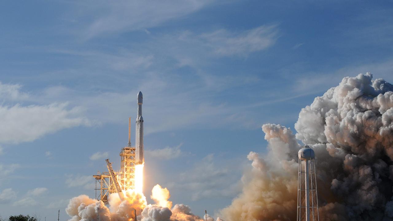 The SpaceX Falcon Heavy launches from Pad 39A at the Kennedy Space Center in Florida, on February 6, 2018, on its demonstration mission, carrying CEO Elon Musk's cherry red Tesla roadster to an orbit near Mars. Picture: AFP PHOTO / JIM WATSON