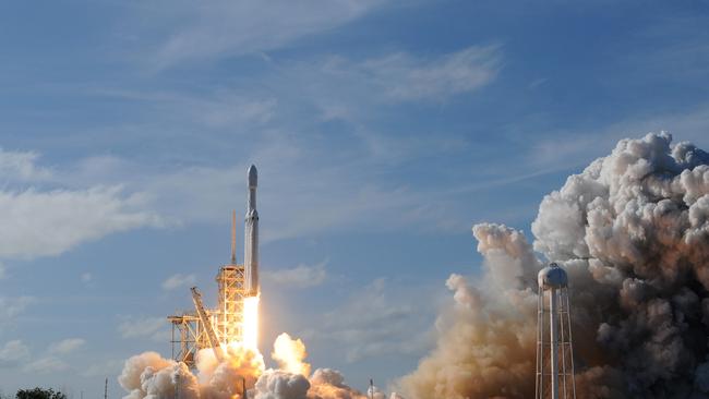 The SpaceX Falcon Heavy launches from Pad 39A at the Kennedy Space Center in Florida, on February 6, 2018, on its demonstration mission, carrying CEO Elon Musk's cherry red Tesla roadster to an orbit near Mars. Picture: AFP PHOTO / JIM WATSON