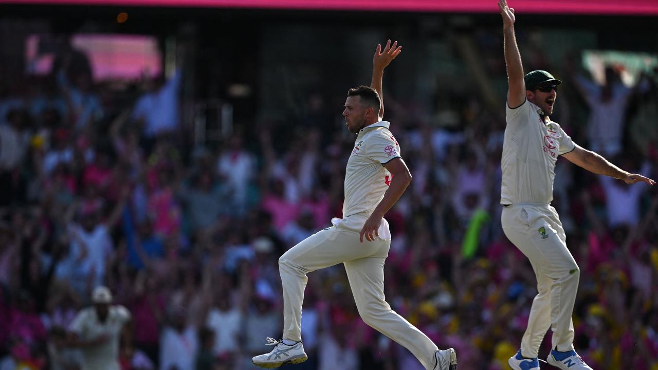 Josh Hazlewood (L) celebrates with Mitch Marsh after taking the wicket Salman Agha. Picture: AFP