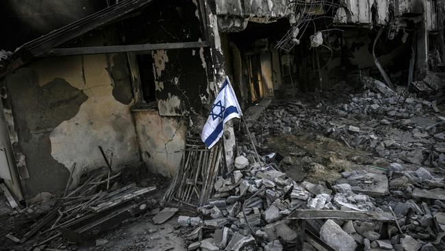 An Israeli flag placed at a destroyed house in Kibbutz Beeri in southern Israel. Picture: AFP