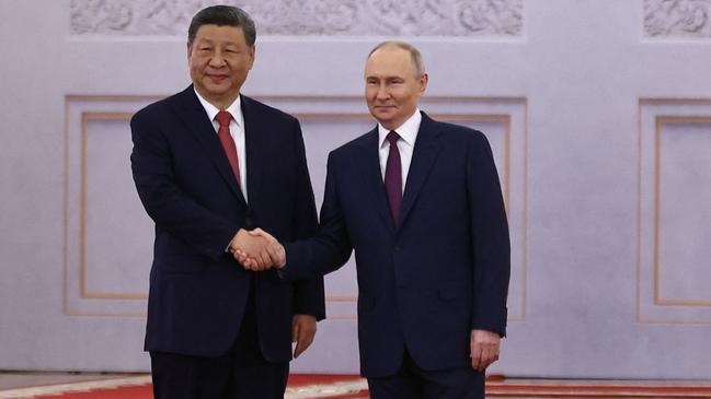 Russian President Vladimir Putin and his Chinese counterpart Xi Jinping shake hands during a welcoming ceremony at the Kremlin. Picture: AFP