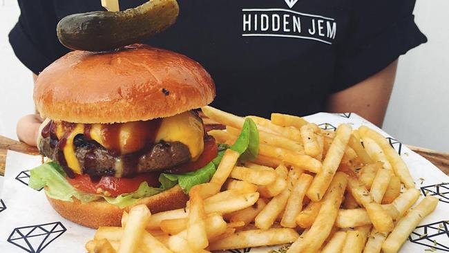 Hidden Jem's Wagyu Beef Burger ($20) with tomato, caramelised onion, lettuce, pickles and barbecue sauce served with fries. Picture: Hidden Jem