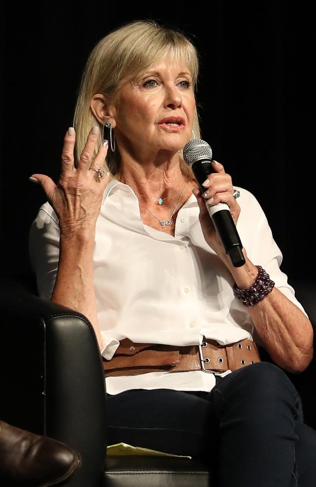 Olivia Newton-John and husband John Easterling talking at cannabis seminar in Portland and showing personal photos to the group as they talk. Picture: Clint Brewer