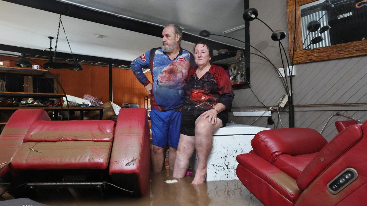 Clitheroe Street residents David and Tracy Ebert look for items to salvage from the lounge room, after flood water inundated their Cardwell home overnight. Picture: Brendan Radke