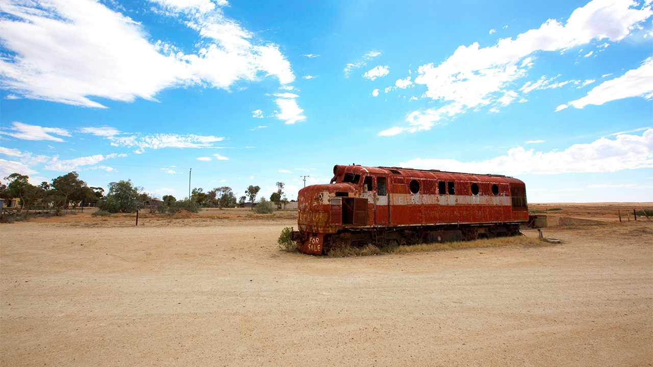 <p>Come to this part of South Australia and you will see haunting remnants of the Old Ghan everywhere &ndash; sidings over old creek crossings, ageing locomotives, rail lines disappearing to vanishing points on some of the flattest plains in the country. In the dusty red fields around the abandoned town of Farina I souvenired a rusted 100-year-old railway spike. You just can&rsquo;t escape it. Its legacy is everywhere.</p><p>To the northeast of so-called Ghantowns, outposts like Farina and Marree and Coward Springs, is Kati Thanda. Lake Eyre. At more than 9500sq km, when full it&rsquo;s Australia&rsquo;s largest salt lake and at 15m below sea level our continent&rsquo;s lowest point.</p>