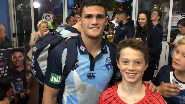 Blues halfback Nathan Cleary with PCYC member Riley Dack.