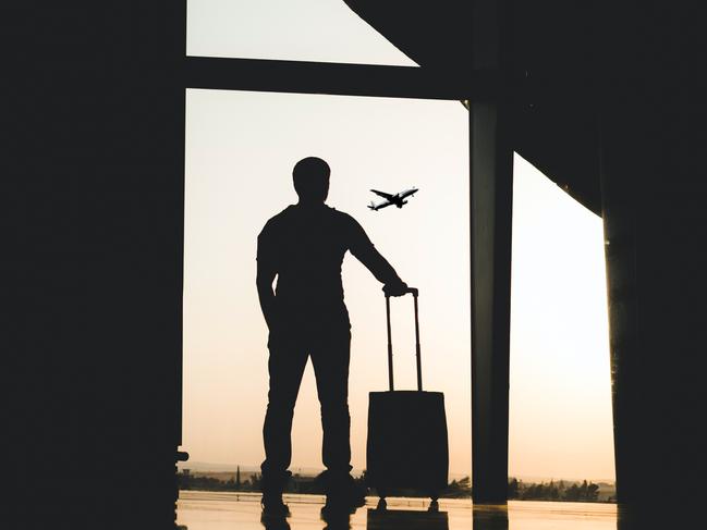 silhouette of man with luggage