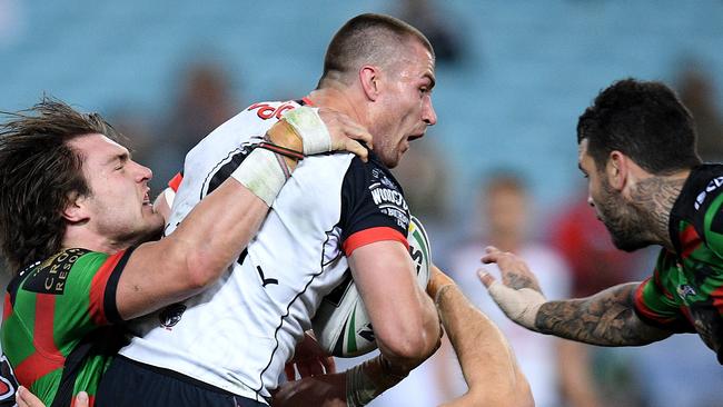 Kieran Foran of the Warriors is tackled.