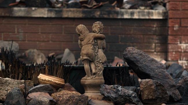 The statue still standing in the ruins of the property four days after the disastrous fire. Picture: Gary Ramage