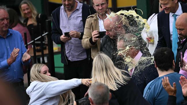 A woman throws a milkshake over Nigel Farage, during his general election campaign launch in Clacton-on-Sea. Picture: AFP.