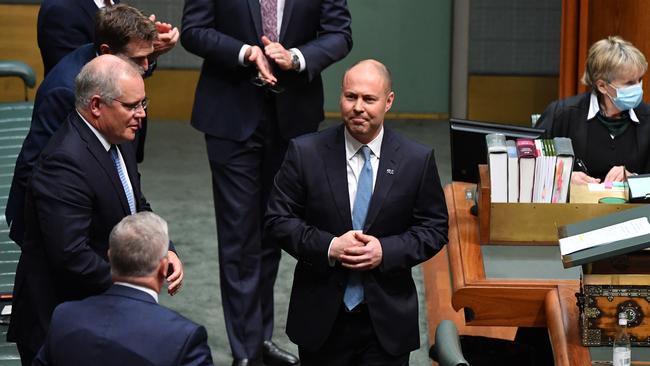 Prime Minister Scott Morrison (L) watches as Treasurer Josh Frydenberg reacts after the budget delivery in the House of Representatives. Picture: Getty Images