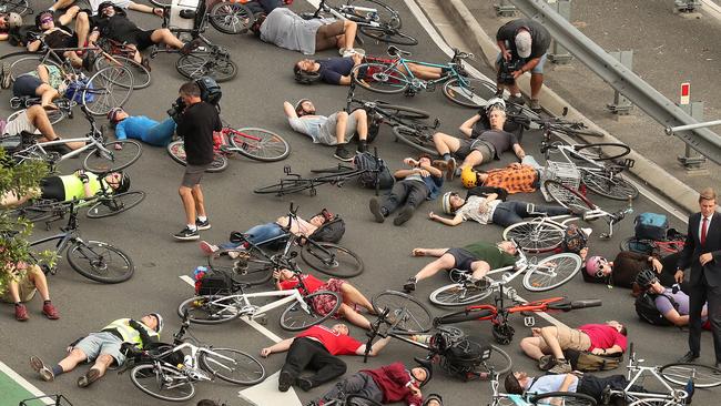 The "die-in" cyclist protest during peak hour traffic at the corner of Vulture and Graham Streets, South Brisbane. Picture: Liam Kidston.