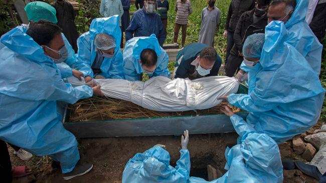 Relatives prepare for the burial of a COVID-19 victim in Srinagar, India. Picture AFP