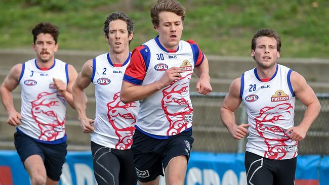 Injured Bulldogs run laps at Whitten Oval. Picture Jake Nowakowski