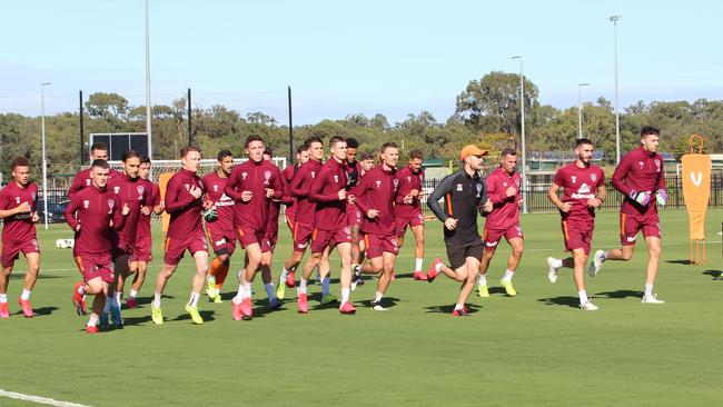 Brisbane Roar players are back on the training pitch but coach Robbie Fowler is yet to return from the UK.