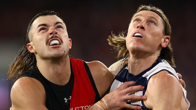 Essendon ruckman Sam Draper (left) was the victim in a horror passage of play which left the Bombers 15 points down in the third quarter against Geelong. Picture: Graham Denholm / Getty Images