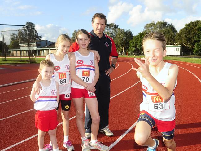 L to R: Samuel O'Donnell - 4, Grace O'Donnell - 10, , Laura Roderick -10 and President Con Kotis watch as James Kotis - 10 races by at ES Marks Athletic track. Eastern Suburbs Little Athletics is begining it's season. Picture: John Appleyard