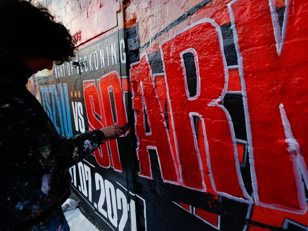 Painters replace Michael Zerafa on the mural with Spark’s name.