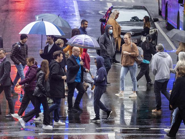 BRISBANE AUSTRALIA - NewsWire NCA Photos JULY 5, 2022: Queenslanders rug up as heavy rain and colder than average temperatures hit Brisbane today. NewsWire / Sarah Marshall