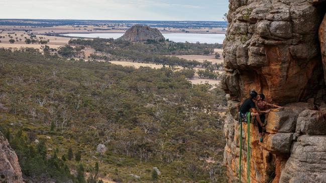 Ms Edwards and Mr Shepherd steal a quick kiss after a challenging climb up a section soon to be banned. Picture: The Australian / Nadir Kinani