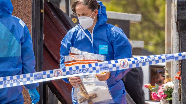 Forensic officers collect evidence at the cemetery. Picture: Jason Edwards