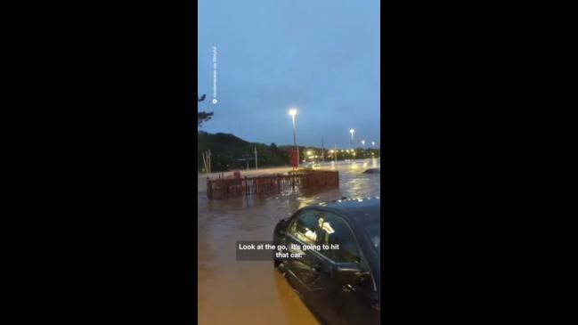 Verandah floats down flooded street