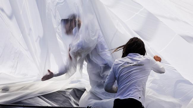 Crew lower the sails on the overall contender Whisper during the 2021 SOLAS Big Boat Challenge.