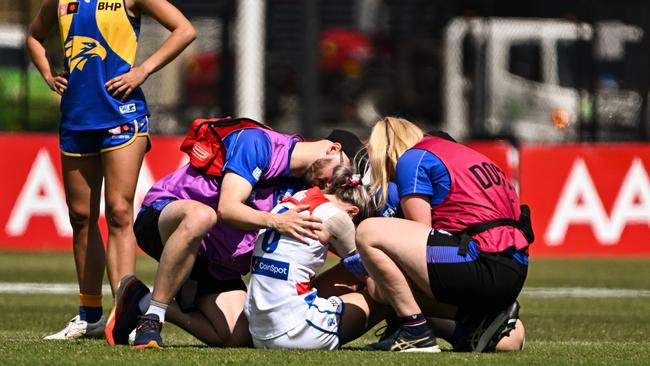 Kirsten McLeod is helped after injuring her ankle in her comeback game. Picture: Daniel Carson/AFL Photos via Getty Images