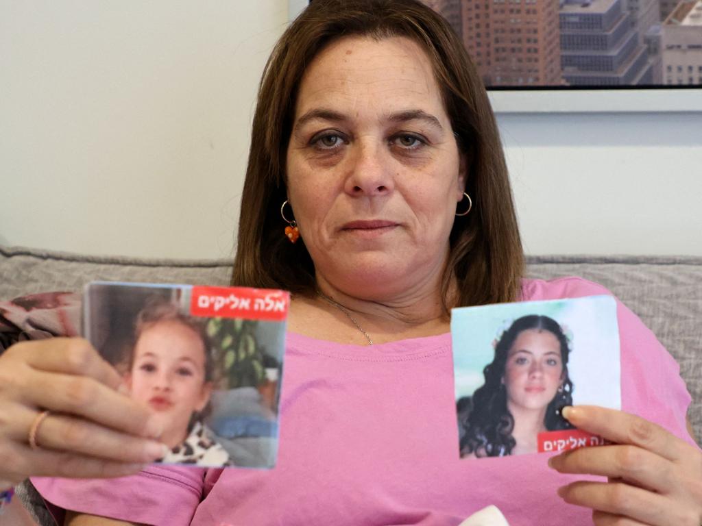 Dafna, 15, and Ela, eight, in photos held by their mother Maayan Zin. Picture: AFP