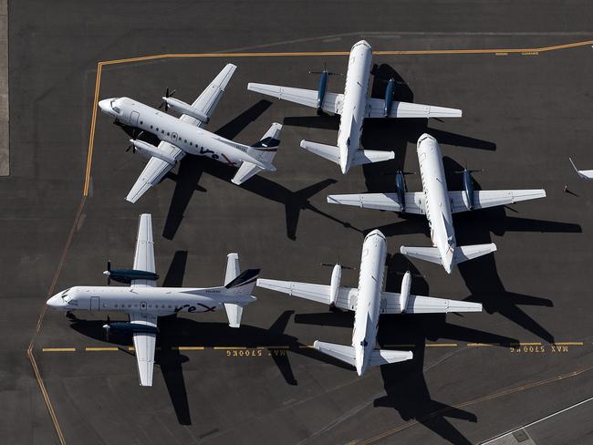 SYDNEY, AUSTRALIA - APRIL 22: An aerial view of Rex Airlines aircraft at Sydney Airport on April 22, 2020 in Sydney, Australia. Restrictions have been placed on all non-essential business and strict social distancing rules are in place across Australia in response to the COVID-19 pandemic.  (Photo by Ryan Pierse/Getty Images)