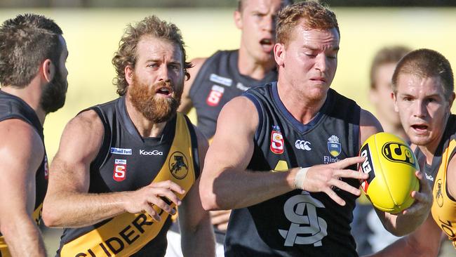 SANFL football - South Adelaide vs Glenelg match at Hickinbotham Oval. Footballer Ty Allen (l) and Peter Rolfe (c).