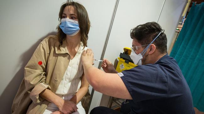 A young woman receives the Pfizer vaccine at the Royal Exhibition Building Vaccination Centre.