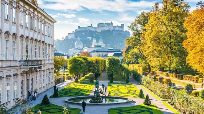 Beautiful Mirabell Gardens with Fortress Hohensalzburg in the background.