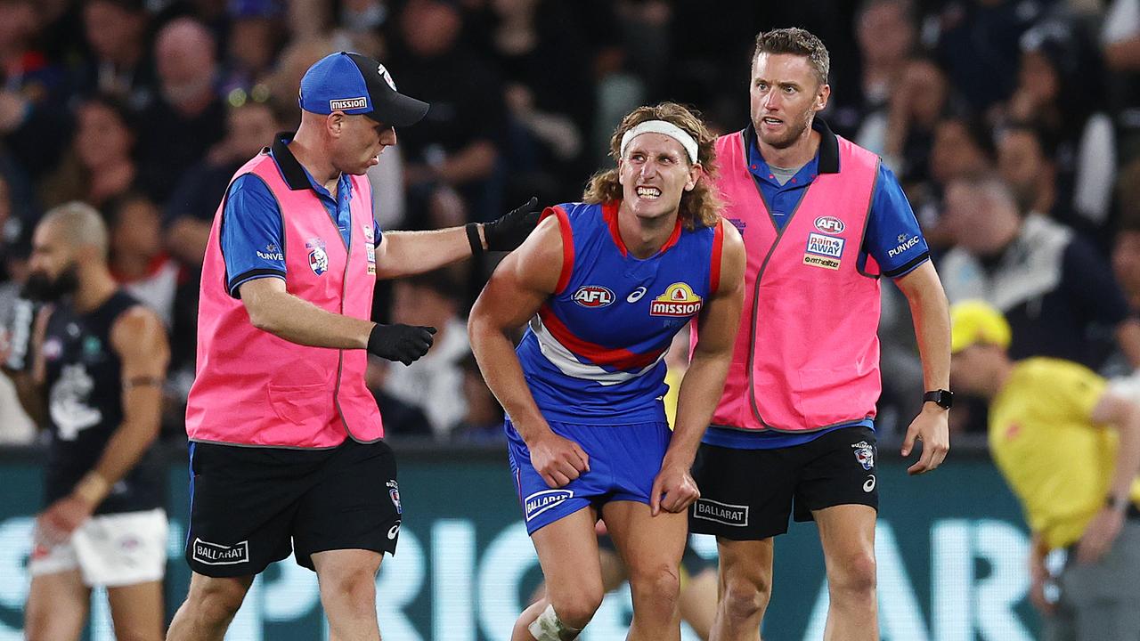 Aaron Naughton heads to the bench in pain in the third quarter. Picture: Michael Klein