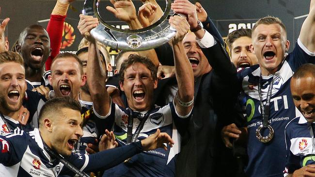 Mark Milligan lifts the A-League trophy.