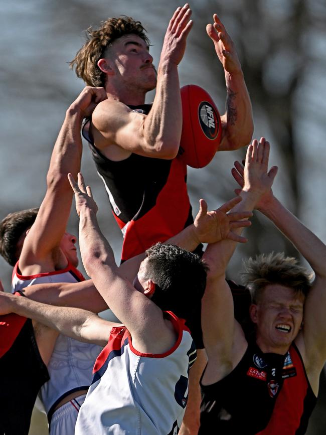 Finnbar Maley crashes the pack for Eltham. Picture: Andy Brownbill