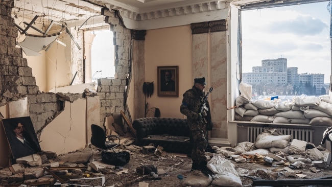A Ukrainian soldier at the destroyed government building in Kharkiv as Russia continues to batter Ukraine's cities with aerial assaults. Picture: Getty