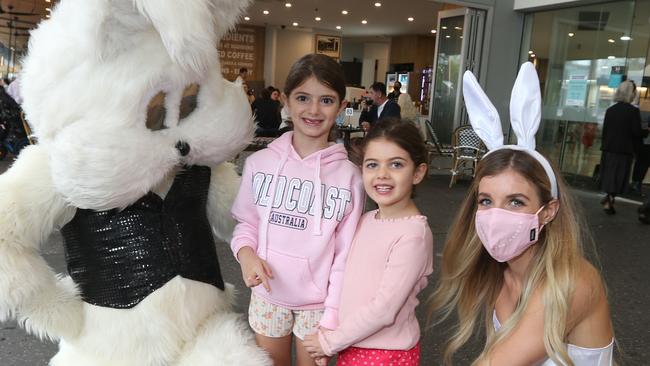 Shop keepers , visitors and Locals during Easter Sunday in the Broadbeach Mall. .Stuffed Rabbit with brisbane visitors Maria Pozzias 6 and her sister Katina Pozzias age 4 and Rabbit controller Tasha Radford   .  Pic Mike Batterham