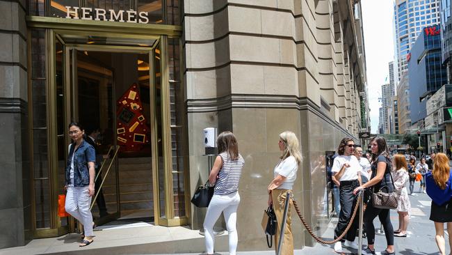 Shoppers queue outside the luxury Hermes boutique in Sydney’s CBD ahead of Christmas.