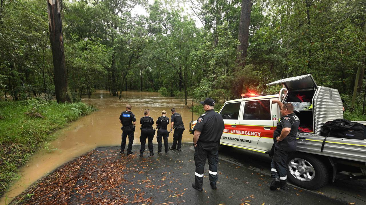 Police and emergency services search after a car was found in floodwaters in Elimbah Tuesday. Picture: Lyndon Mechielsen